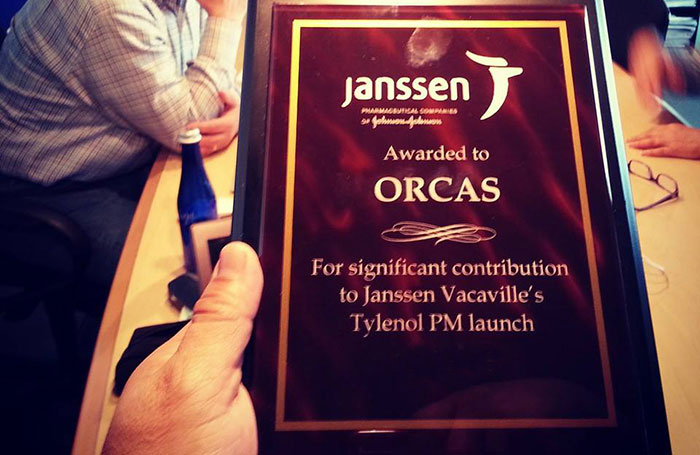 Hand holding janssen award plaque